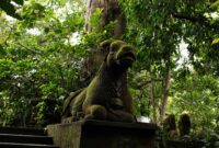 alami villa ubud Explore the mystical moss-covered sculpture surrounded by lush vegetation in Ubud, Bali.