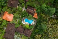 bali villa construction Stunning aerial shot of tropical villa with pool surrounded by lush greenery in Bali.