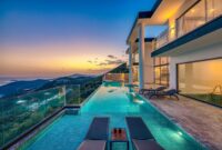 Stunning luxury villa overlooking the ocean with an infinity pool at sunset.